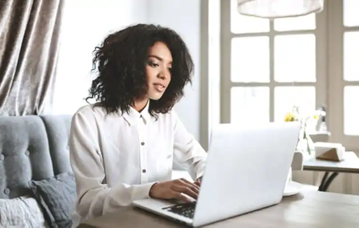 Marketer repurposing blog content on a laptop to recycle content marketing