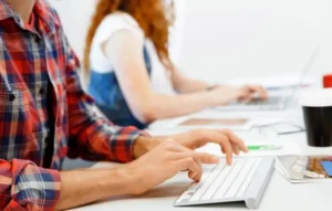 Agency team managing white label content creation on desktop computers