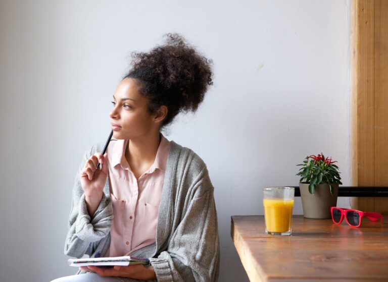 Woman preparing to start creating content with notebook and pen