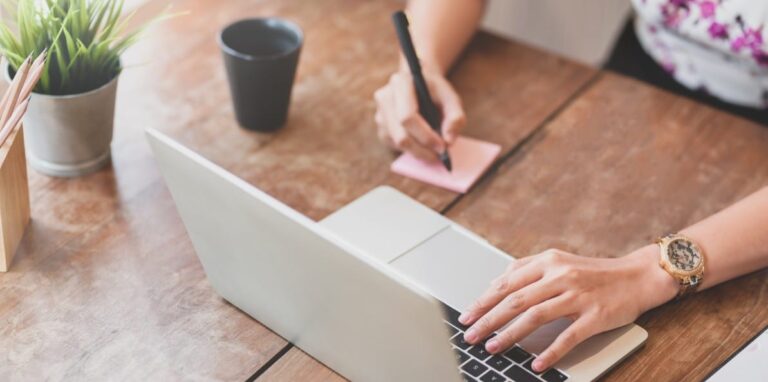 Marketer taking notes while planning content investment strategy