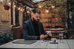 Businessman using smartphone in a cafe