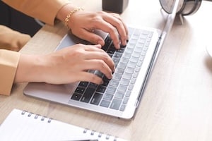 women-worker-typing-on-laptop