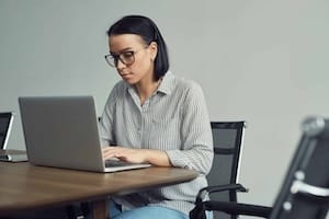 Businesswoman typing on laptop