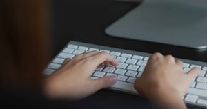 Woman types on the computer