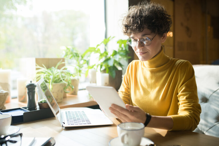 Focused woman planning content schedule at cozy workspace