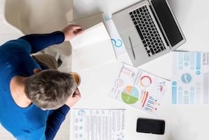 Marketing specialist viewing his notes in office