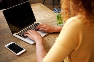 behind-of-young-woman-using-laptop-computer