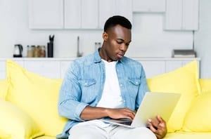 african american man using computer at home