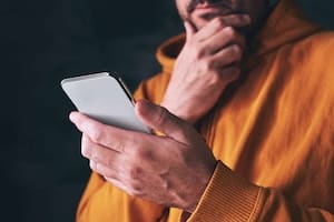 Man using smartphone, reading online message or social media status