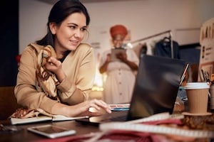 Woman, fashion designer and laptop planning, fabric ideas and internet technology in textile studio