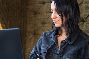 Coach documenting client success stories for content marketing
