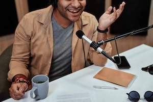 Coach recording podcast episode to boost brand authority and engagement