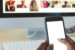 Close up of young African-American businessman using mobile phone