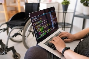 Hands of young contemporary disable female programmer touching laptop keys