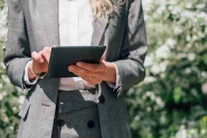 woman-using-tablet-at-spring-background