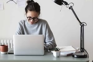 Woman working on a laptop in her home