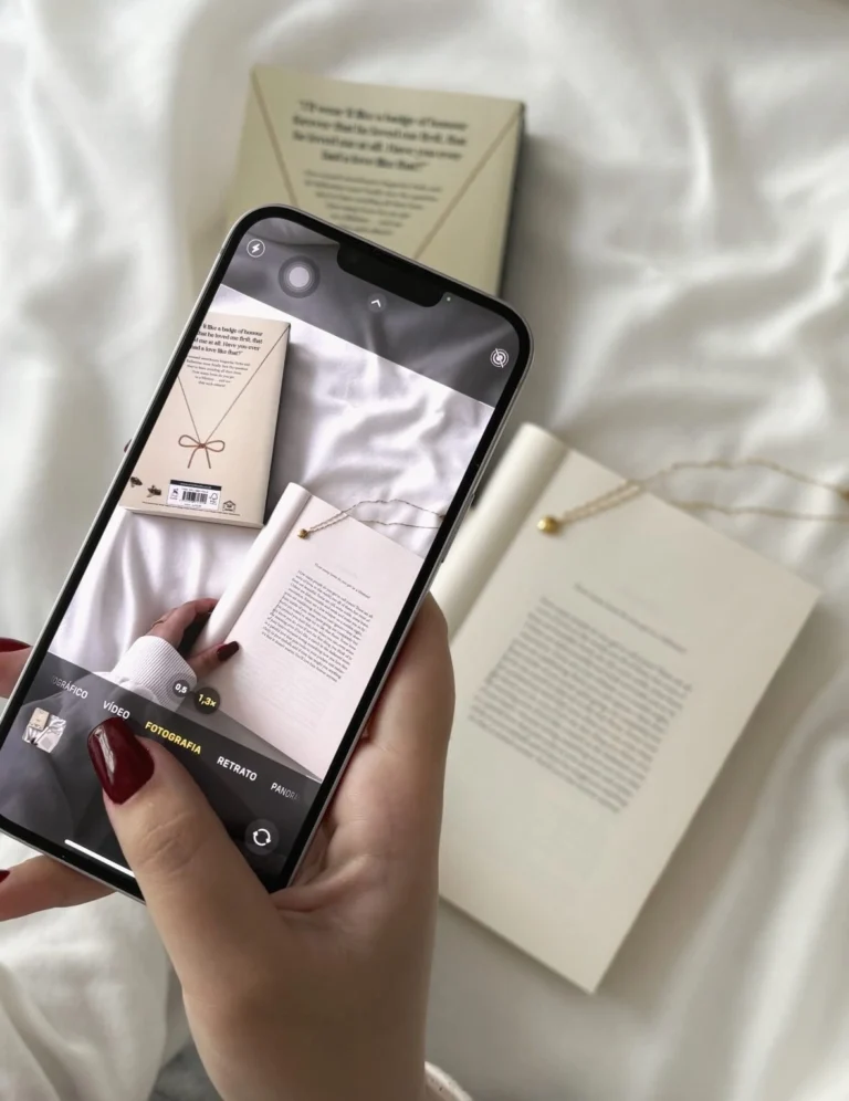 Woman capturing flat lay of books and jewelry for Instagram content creation