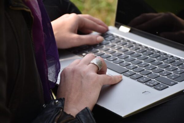 Person typing blog post on laptop with industry myth headline