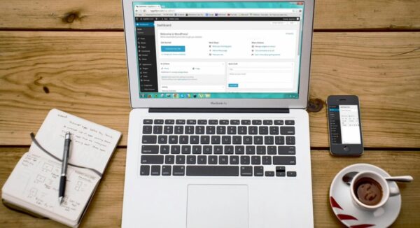 laptop showing wordpress website updates and editing page