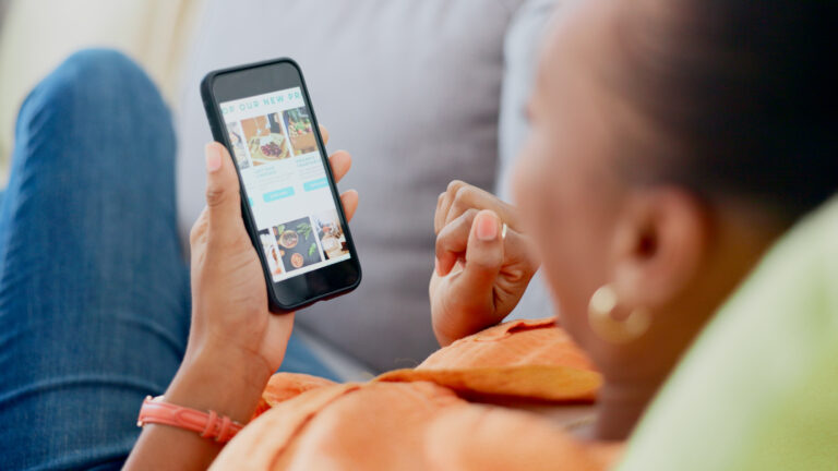 Business owner checking their online reputation via smartphone