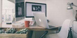 Open Laptop on desk with two monitors