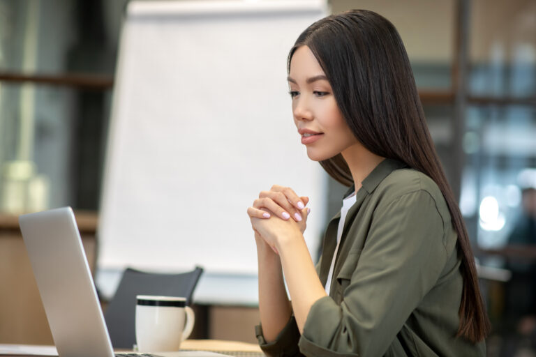 Focused entrepreneur planning her online brand strategy