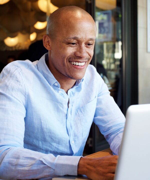 Man smiling while updating website for professional branding