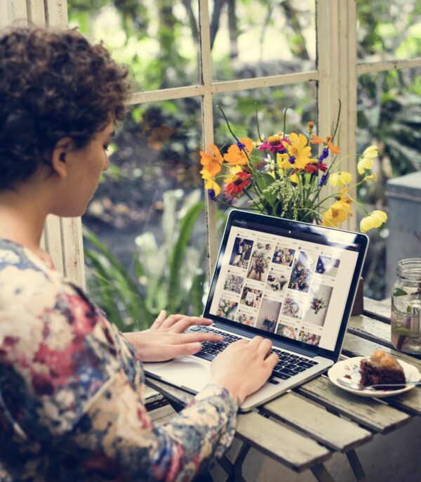 Businesswoman reviewing website presence surrounded by flowers