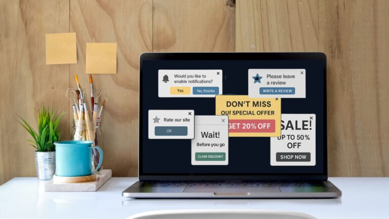 Overloaded laptop screen displaying multiple intrusive website popups, including sales offers, reviews, and notifications