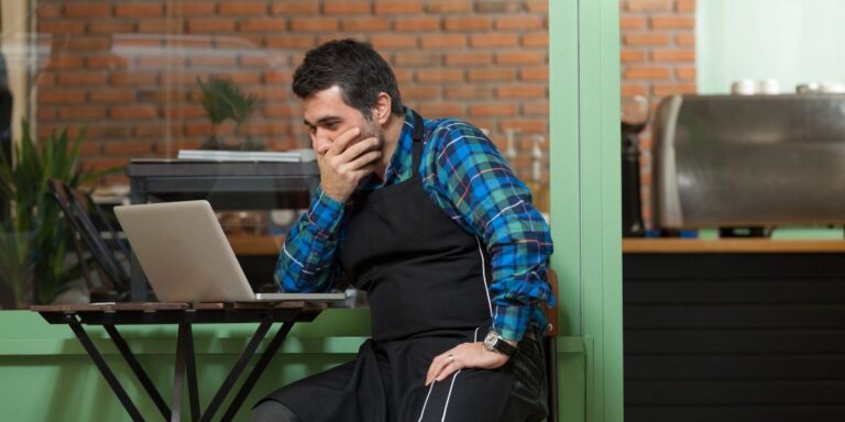 Business owner facing a website hack crisis on laptop