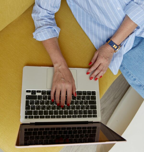 Person browsing a website on a laptop while seated, symbolizing the emotional response to first website impressions