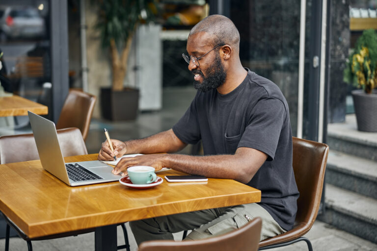 Entrepreneur planning brand content at coffee shop