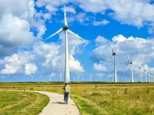 Bicyclist riding near wind turbines symbolizing steady email growth strategy