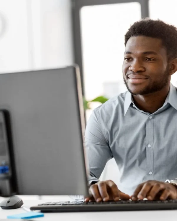 Man smiling while reviewing visual design elements on desktop