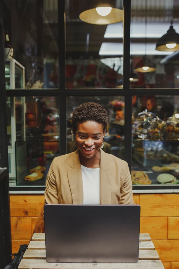 Confident business owner reviewing her website content after implementing trust-building homepage changes.