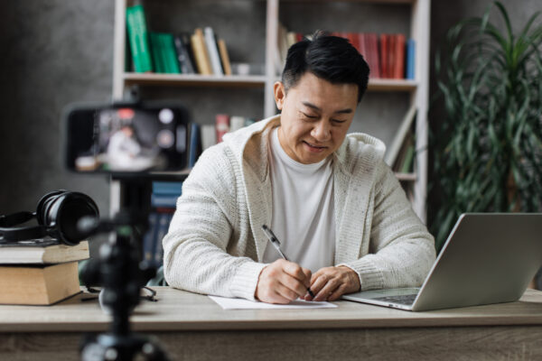 Marketer taking notes on structured content during a video shoot about AI search visibility