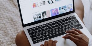 Person working on a laptop reviewing website pages to improve internal linking structure