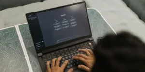 Person typing on a laptop screen displaying ChatGPT, representing how AI crawling tools read and process website content during Generative Engine Optimization (GEO).