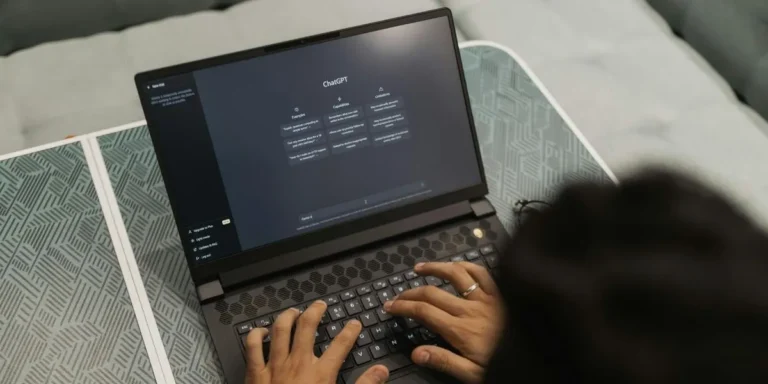 Person typing on a laptop screen displaying ChatGPT, representing how AI crawling tools read and process website content during Generative Engine Optimization (GEO).