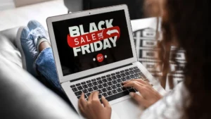 Person browsing a laptop showing a Black Friday sale banner to emphasize peak-season ecommerce urgency for website conversions.