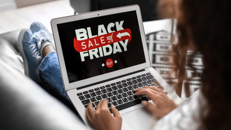 Person browsing a laptop showing a Black Friday sale banner to emphasize peak-season ecommerce urgency for website conversions.