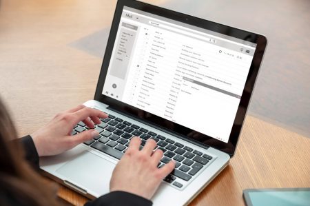 Email client list, woman hand on the computer laptop, inbox e mail message on the screen, close up email