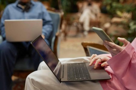 Driving website traffic through strategic social media use People using laptops and phones to manage social media content