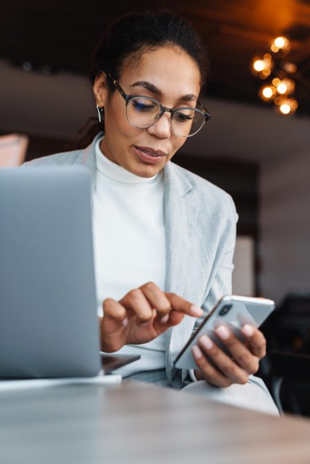 Image of african american businesswoman working on laptop in off email