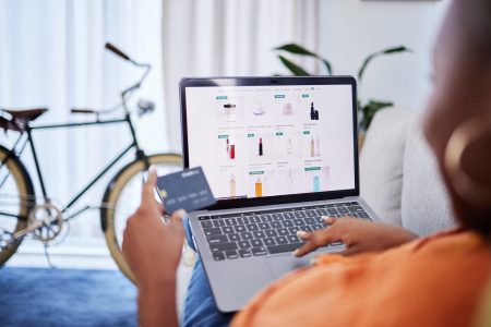 Customer making an online purchase using credit card on laptop