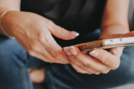 Woman engaging with Instagram content on smartphone at home